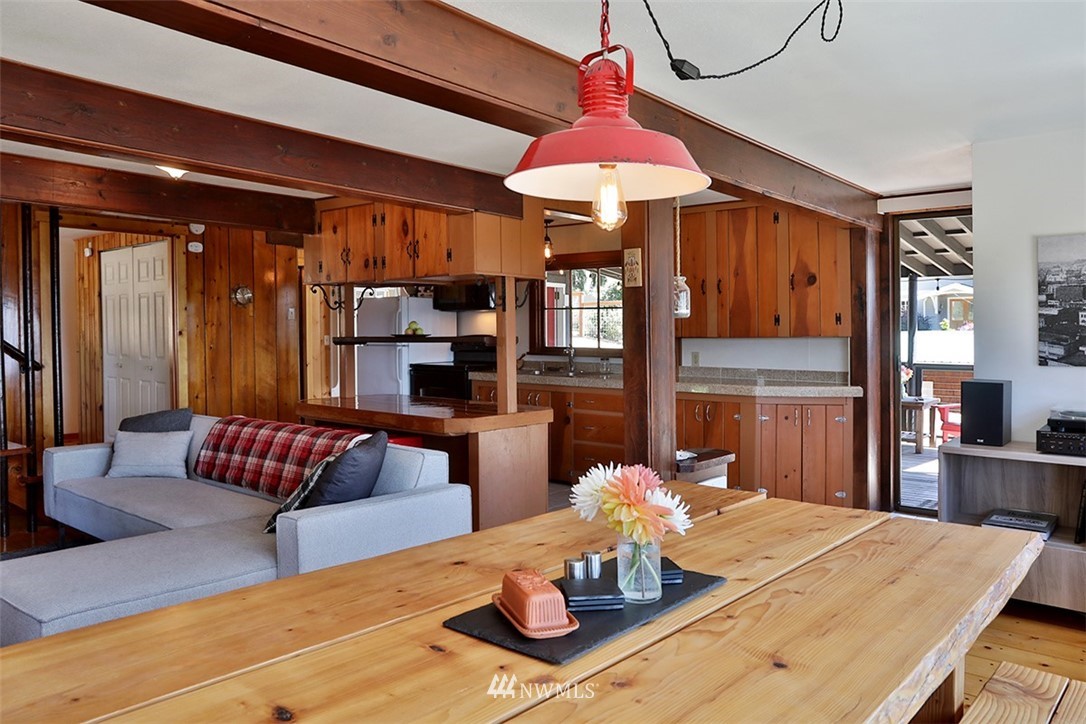 5837 Mutiny Bay Road Freeland, WA 98249 - Photo 10 of 40 a view of a dining room with furniture a chandelier and wooden floor