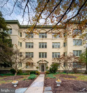 a front view of a building with a garden