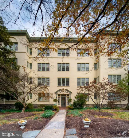 a front view of a building with a garden