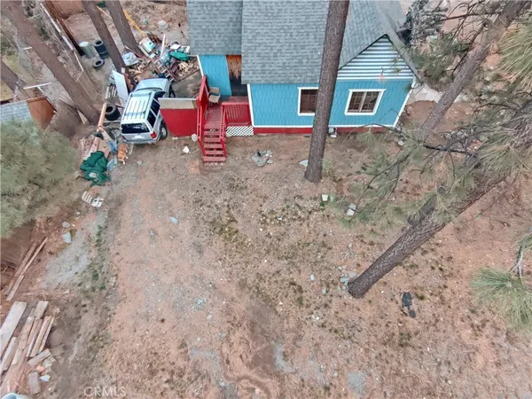 a backyard of a house with chairs and table