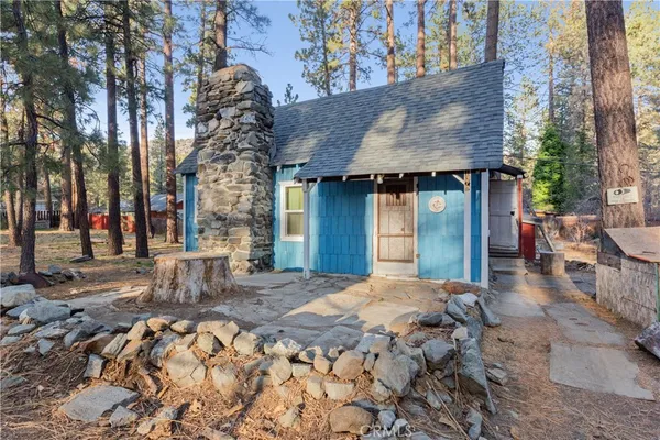 a view of a house with a yard and sitting area