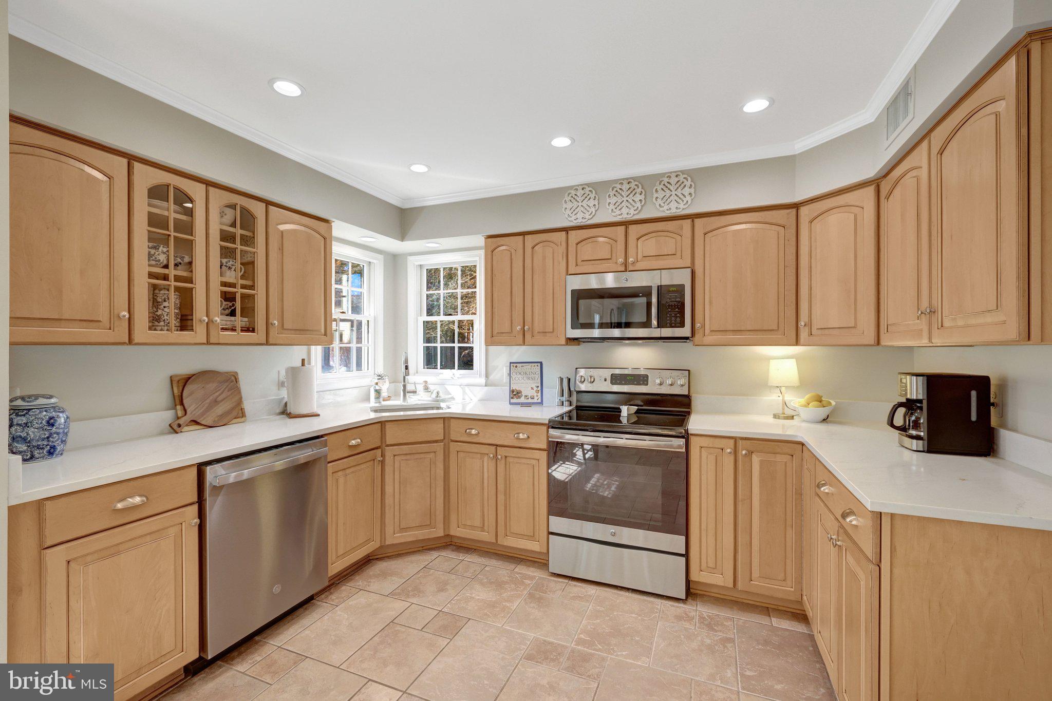 21039 Barcroft Way Sterling, VA 20164 - Photo 16 of 63 a kitchen with stainless steel appliances granite countertop a stove sink microwave and cabinets