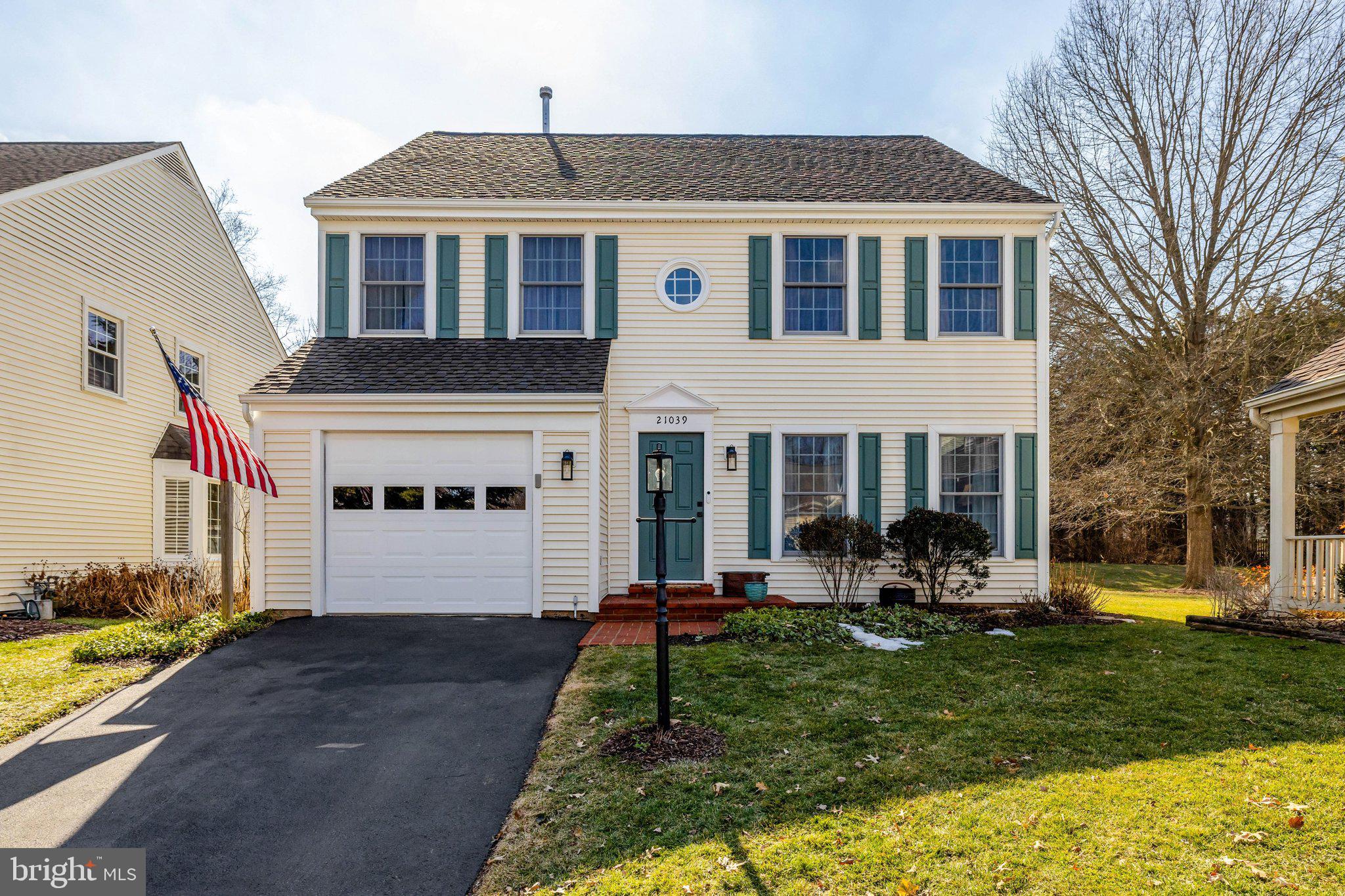 21039 Barcroft Way Sterling, VA 20164 - Photo 2 of 63 a front view of a house with garden