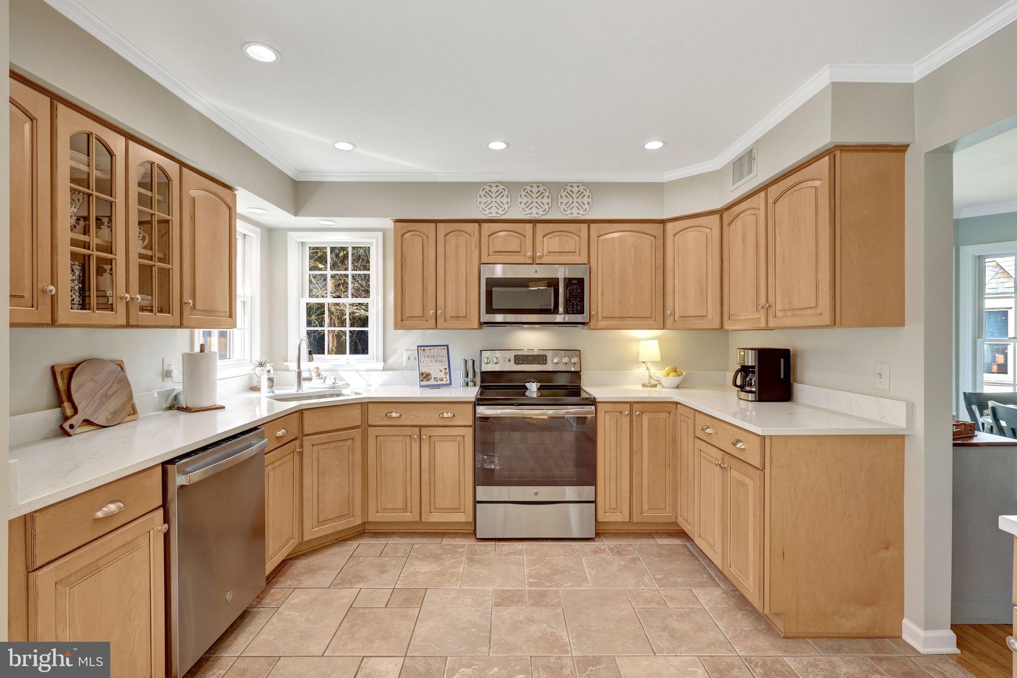 21039 Barcroft Way Sterling, VA 20164 - Photo 21 of 63 a kitchen with stainless steel appliances granite countertop a sink and dishwasher a stove top oven with wooden floor