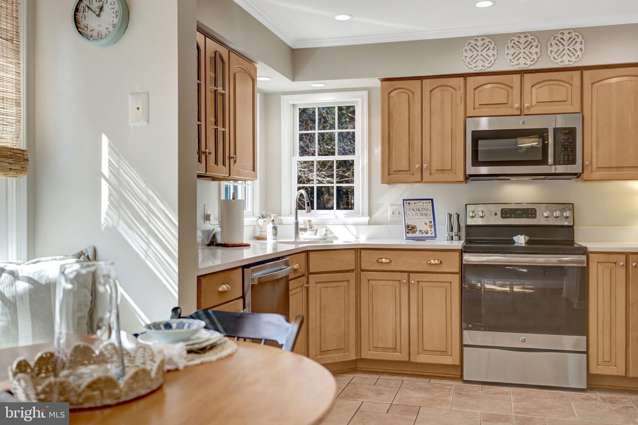 21039 Barcroft Way Sterling, VA 20164 - Photo 24 of 63 a kitchen with stainless steel appliances a sink a stove and a microwave