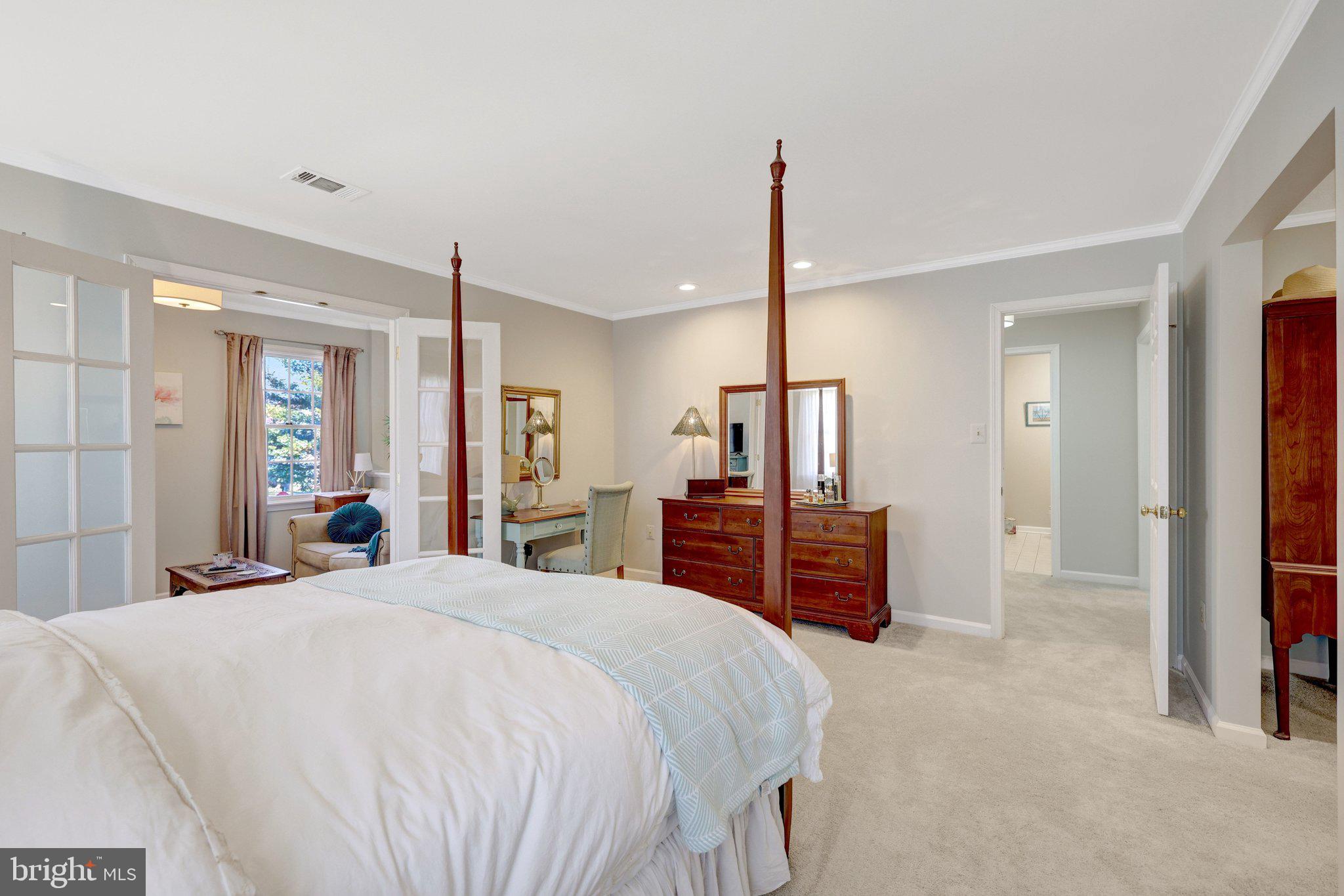 21039 Barcroft Way Sterling, VA 20164 - Photo 32 of 63 a large bedroom with a bed and a flat screen tv