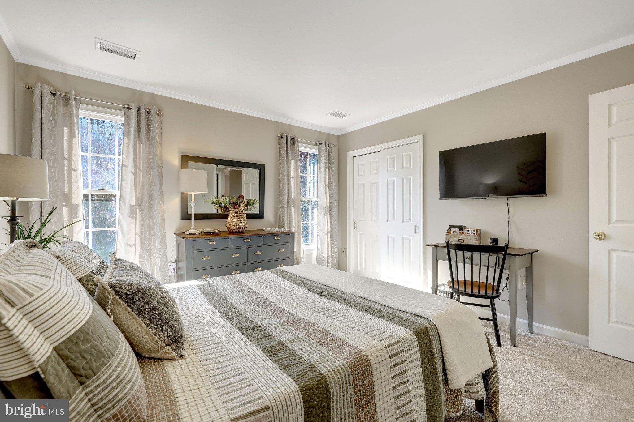 21039 Barcroft Way Sterling, VA 20164 - Photo 41 of 63 a bedroom with a bed and a flat screen tv