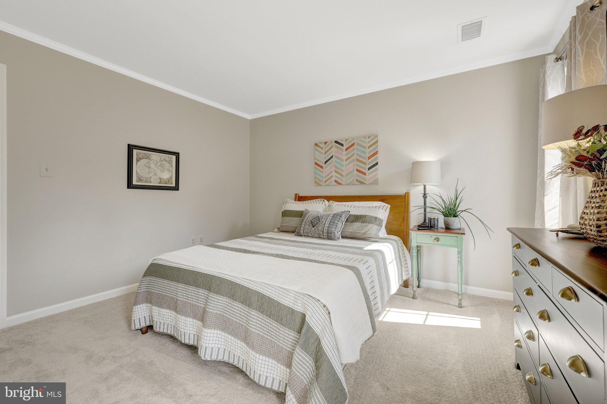 21039 Barcroft Way Sterling, VA 20164 - Photo 42 of 63 a bedroom with a bed and a flat screen tv