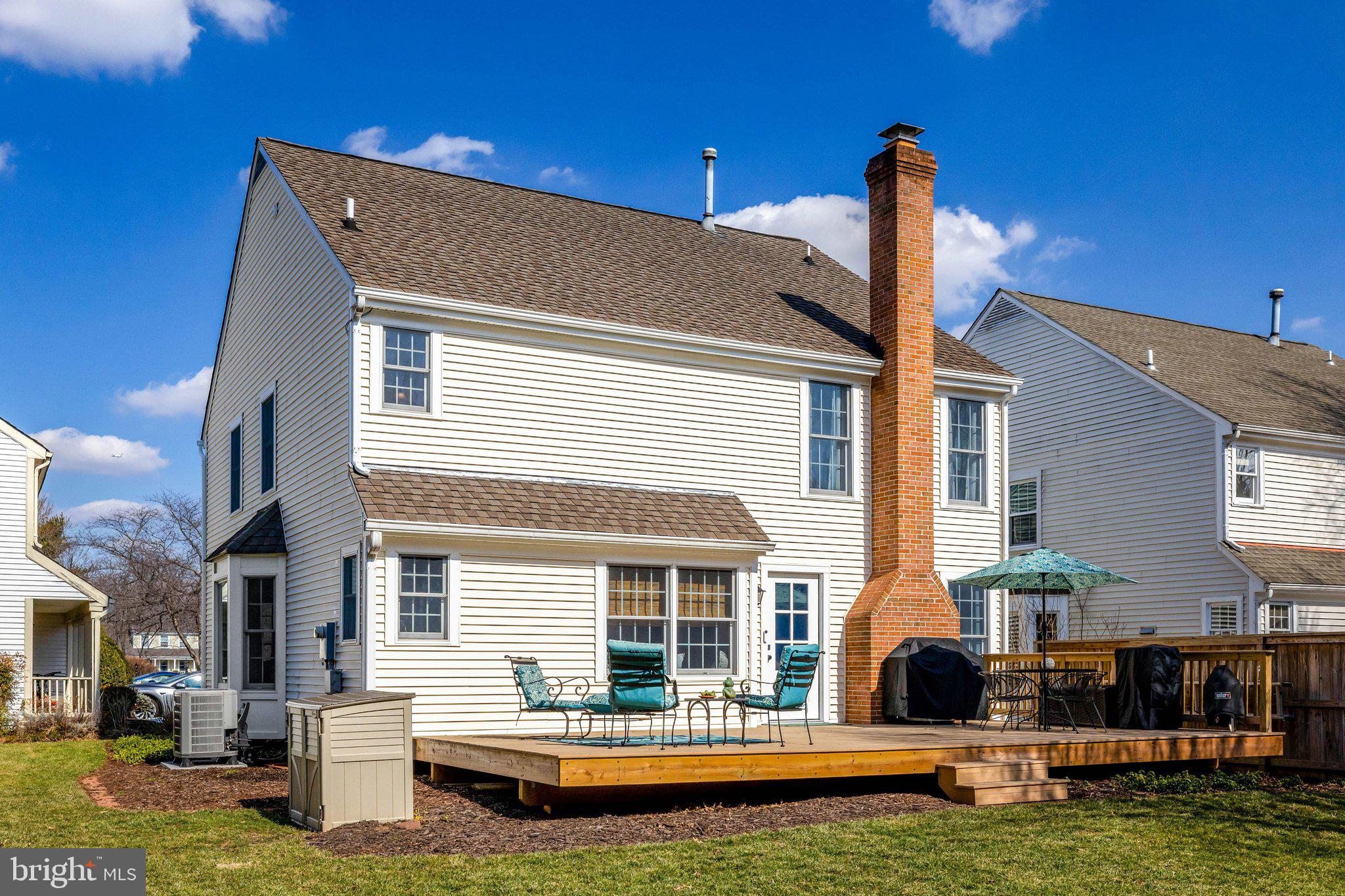21039 Barcroft Way Sterling, VA 20164 - Photo 51 of 63 a front view of a house with a garden and yard