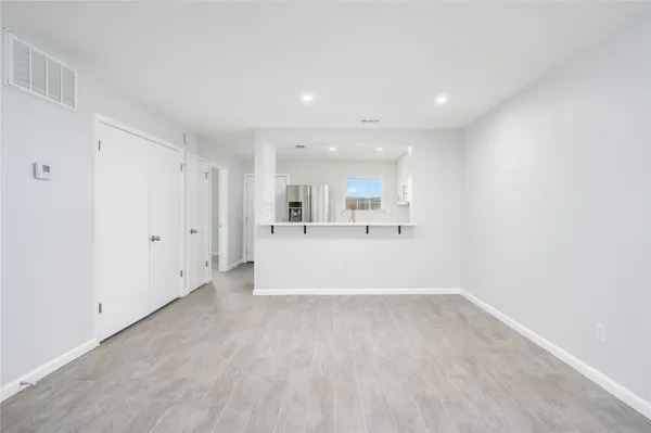 a view of a kitchen with a sink and a refrigerator