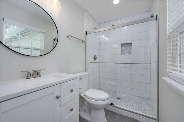 a bathroom with a sink a toilet and a mirror