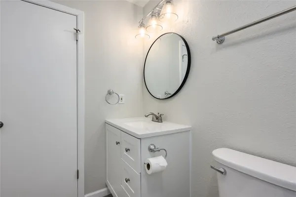 a bathroom with a sink a toilet and a mirror