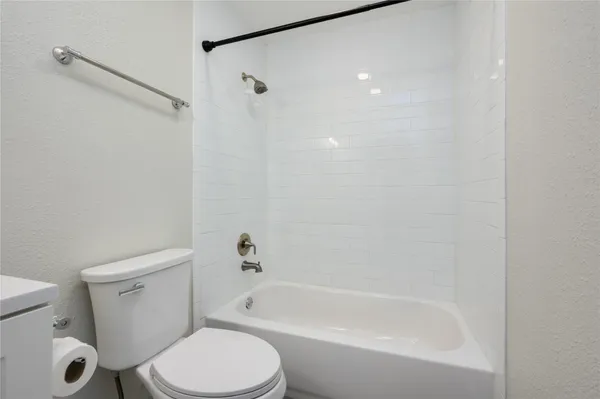 a bathroom with a toilet and a bathtub