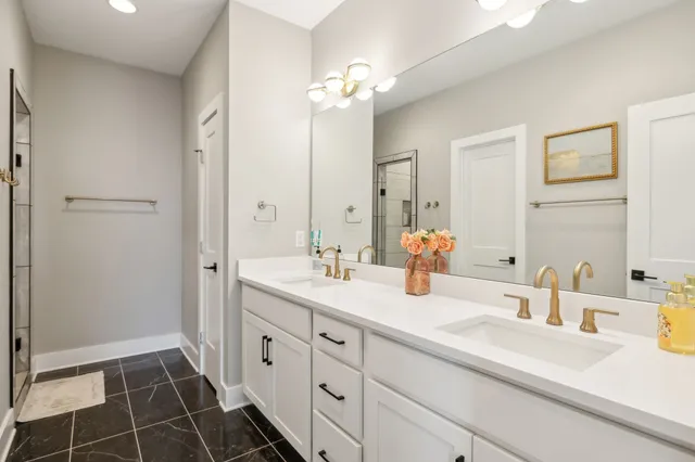 a bathroom with a double vanity sink mirror and