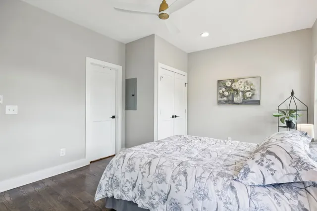 a bedroom with a bed and a painting on the wall