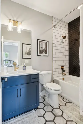 a bathroom with a toilet a sink and bathtub