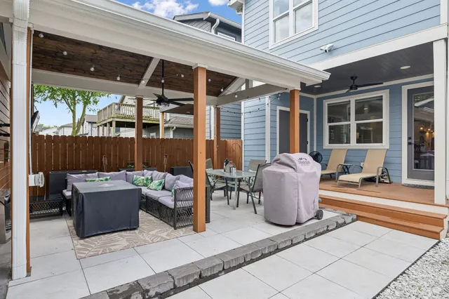 a building outdoor space with patio furniture and potted plants