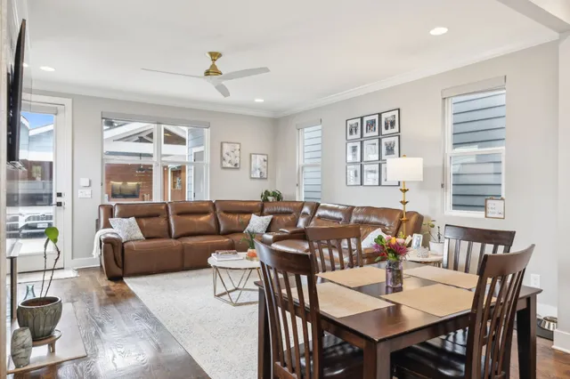 a living room with furniture a chandelier and a table