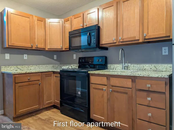 a view of a house with a wooden fence