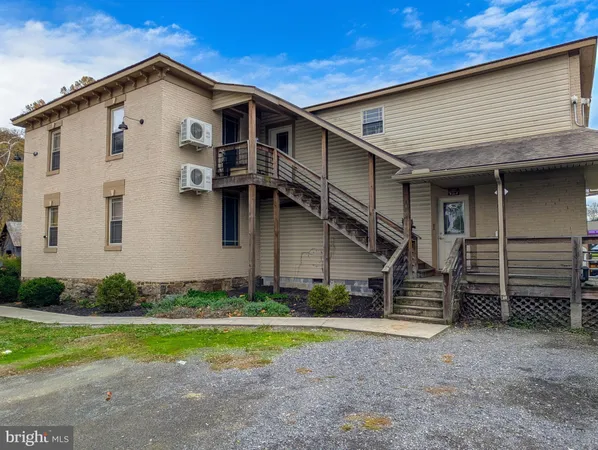 a outdoor space with wooden furniture and stainless steel appliances