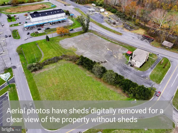 a view of a refrigerator in kitchen and an empty room