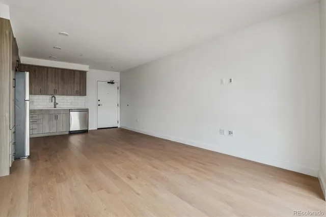a view of a kitchen with a dishwasher and a refrigerator