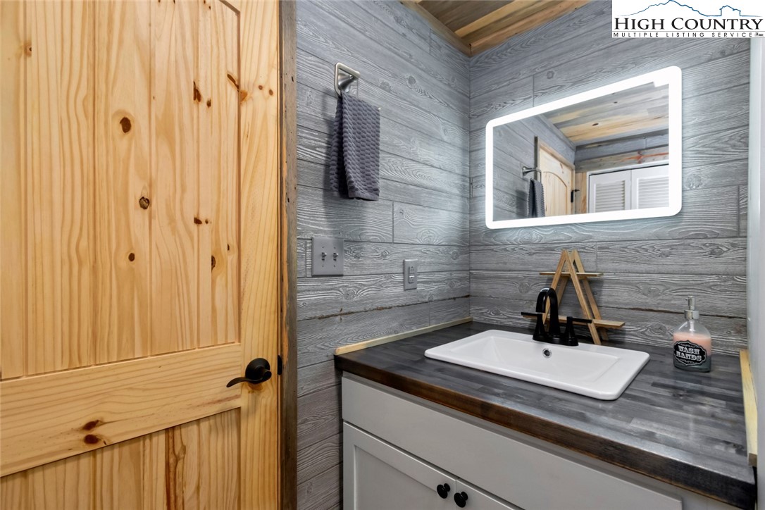 119 Overbrook Trail Beech Mountain, NC 28604 - Photo 24 of 27 a bathroom with a sink and a mirror
