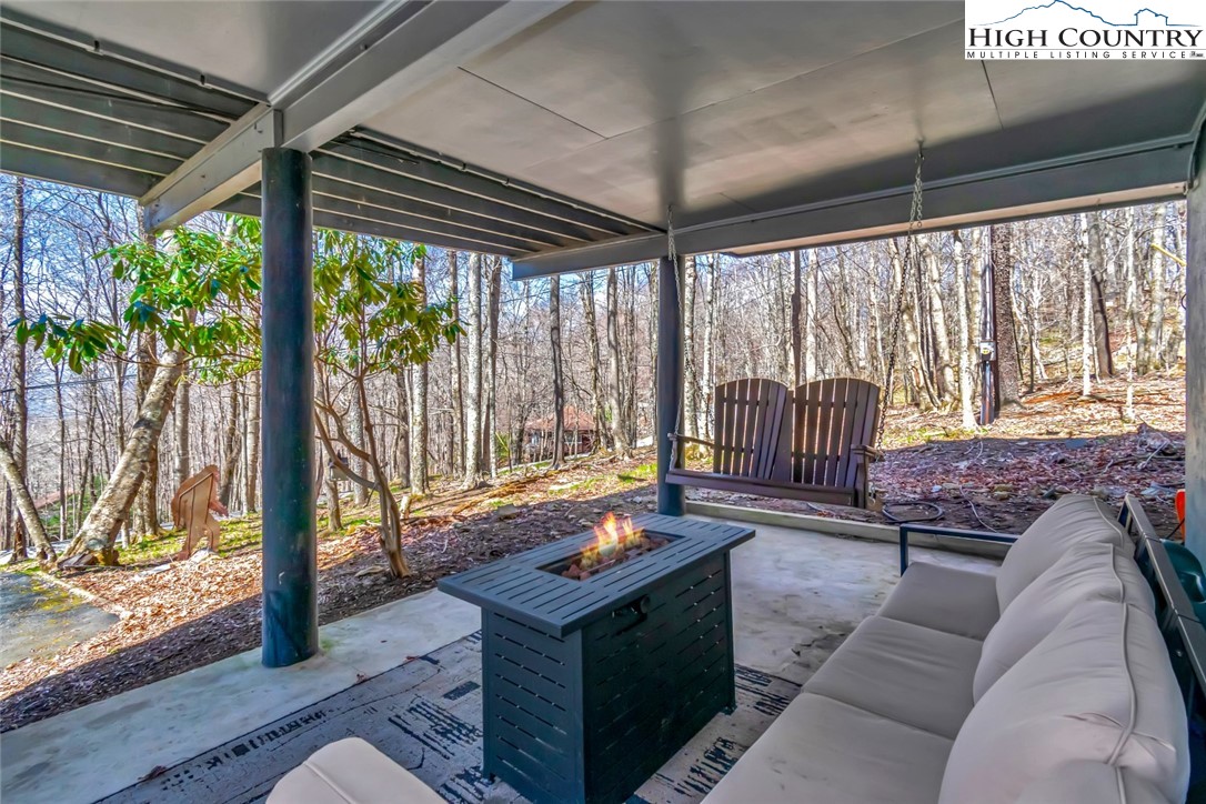 119 Overbrook Trail Beech Mountain, NC 28604 - Photo 27 of 27 a living room with furniture and a floor to ceiling window