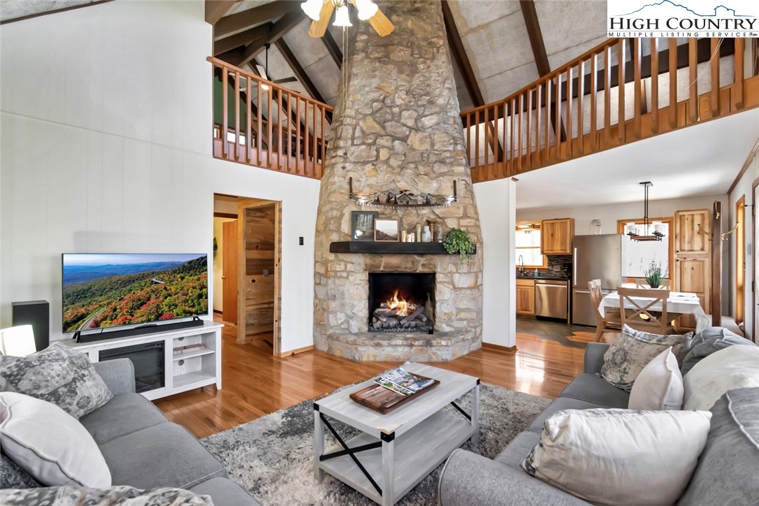 119 Overbrook Trail Beech Mountain, NC 28604 - Photo 3 of 27 a living room with furniture a fireplace and a large window