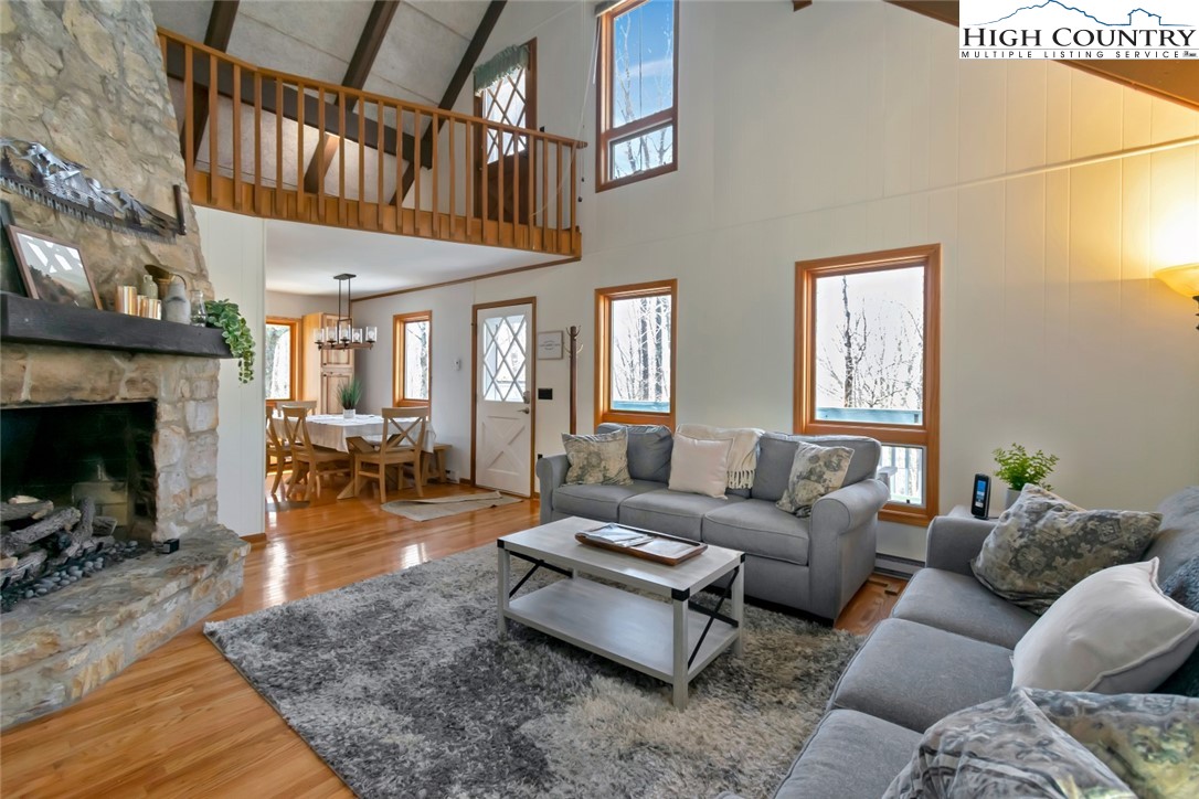 119 Overbrook Trail Beech Mountain, NC 28604 - Photo 5 of 27 a living room with furniture a fireplace and a large window