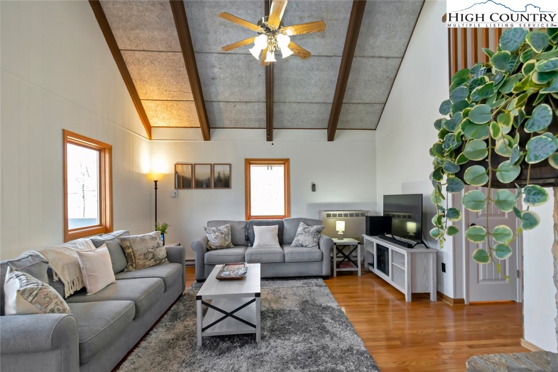 119 Overbrook Trail Beech Mountain, NC 28604 - Photo 6 of 27 a living room with furniture a chandelier and a flat screen tv