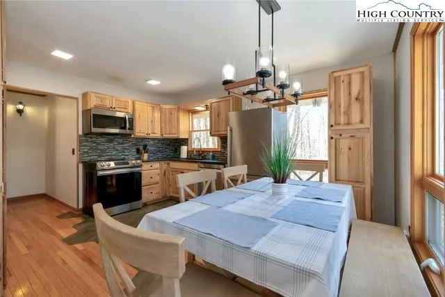 a kitchen with sink refrigerator and microwave