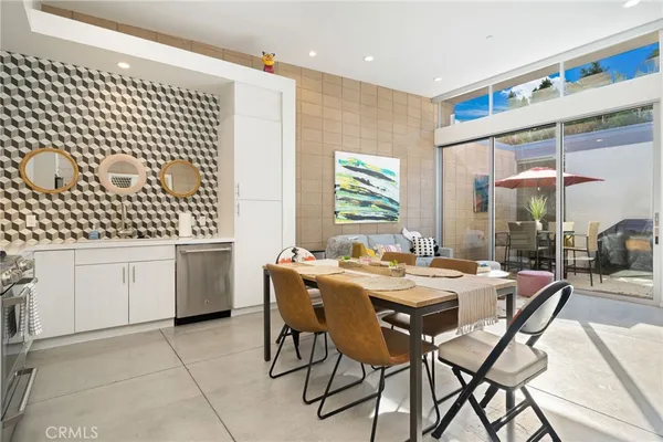 a kitchen with a white cabinets and chairs
