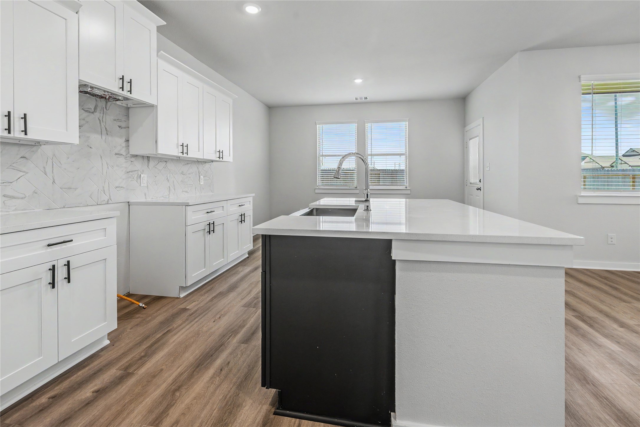 6427 Bolinas Court Rosharon, TX 77583 - Photo 17 of 49 a kitchen with sink cabinets and wooden floor