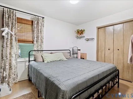 a bedroom with a bed and a dresser