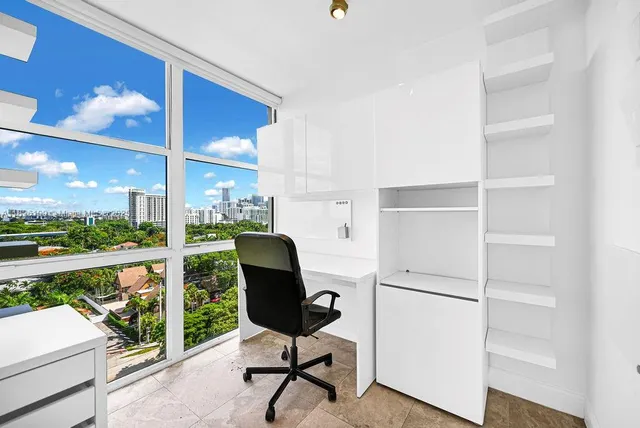 a view of a workspace with furniture and a gate