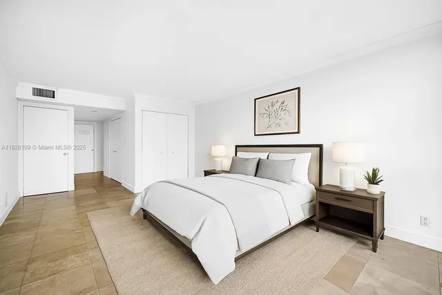 a spacious bedroom with a bed and a cabinets