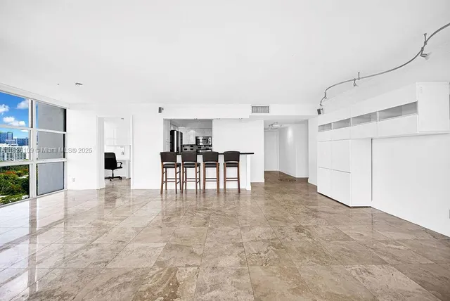 a view of kitchen with furniture and refrigerator