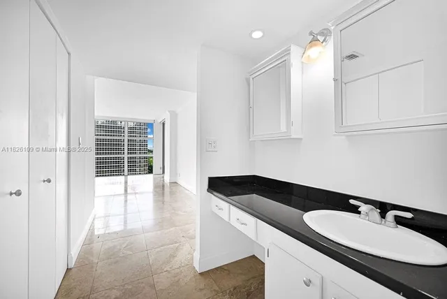 a bathroom with a sink a vanity and a mirror