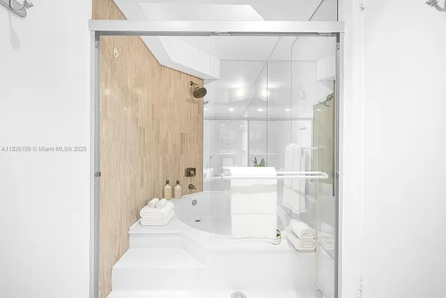 a large white tub sitting next to a bathroom
