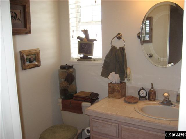 30 Targhee Court Reno, NV 89511 - Photo 8 of 9 a bathroom with a sink vanity and mirror
