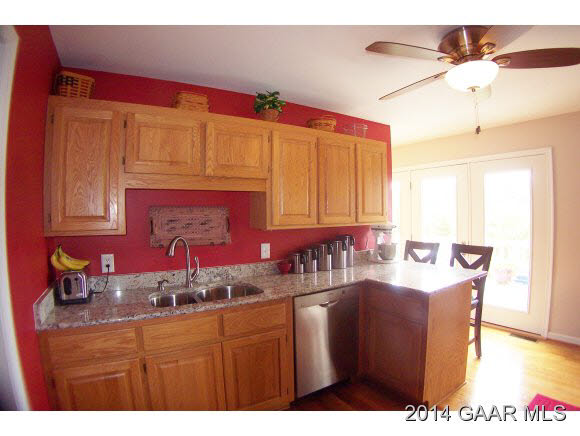 3788 Shutterlee Mill Road Staunton, VA 24401 - Photo 11 of 32 a kitchen with stainless steel appliances granite countertop a sink dishwasher and cabinets with wooden floor