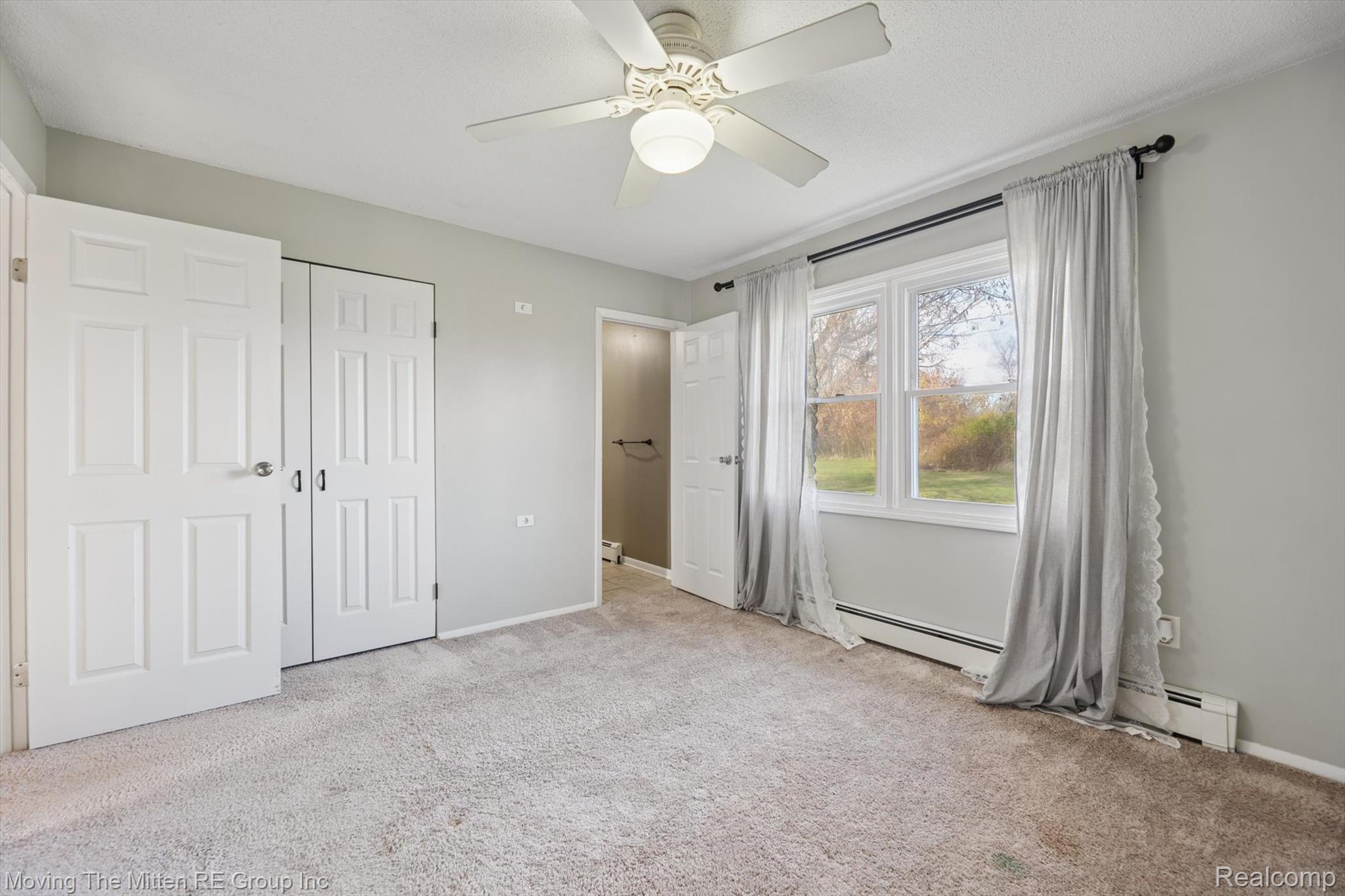 12000 Plank Road Milan, MI 48160 - Photo 17 of 49 Unfurnished bedroom featuring light colored carpet, a closet, and a ceiling fan