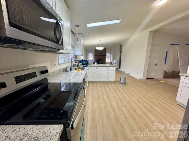 a kitchen with a sink appliances and cabinets