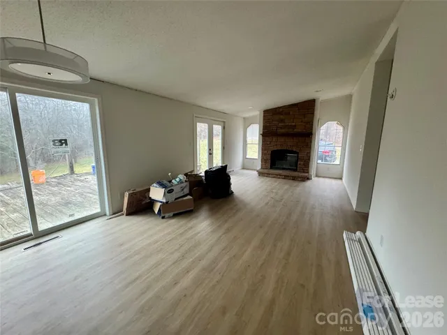 a view of a livingroom with furniture fire place and windows