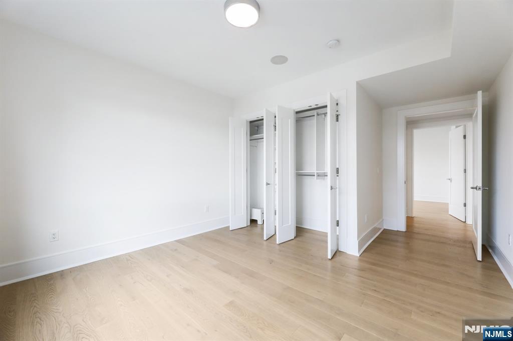 209-211 Hackensack Plank Road, Unit 5B Weehawken, NJ 07086 - Photo 27 of 30 wooden floor in an empty room