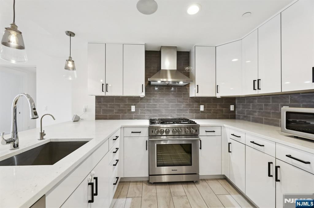 209-211 Hackensack Plank Road, Unit 5B Weehawken, NJ 07086 - Photo 5 of 30 a kitchen with cabinets stainless steel appliances and sink