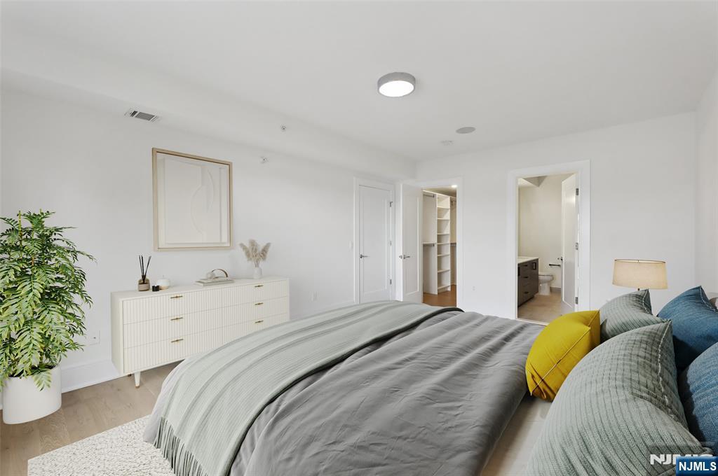 209-211 Hackensack Plank Road, Unit 5B Weehawken, NJ 07086 - Photo 6 of 30 a bedroom with a bed and a potted plant