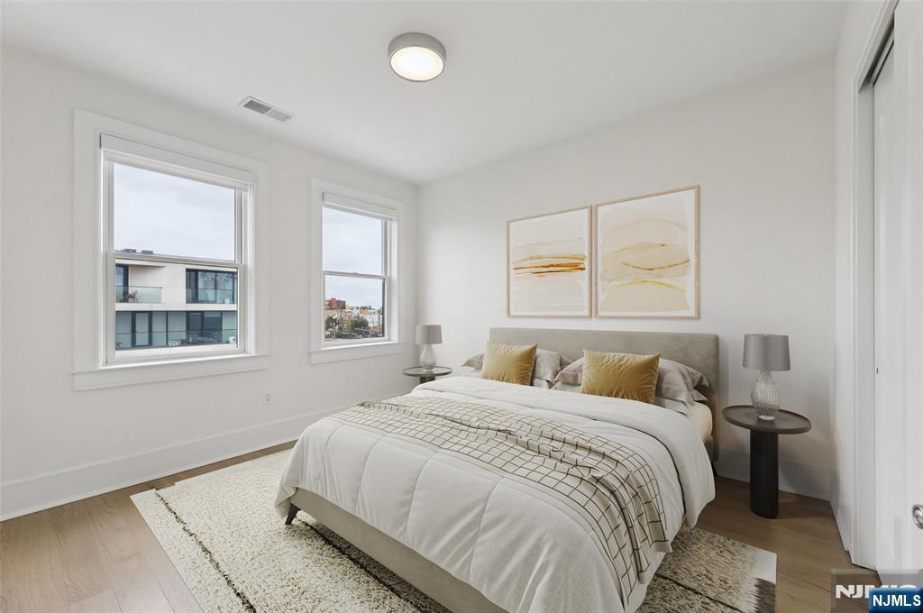 209-211 Hackensack Plank Road, Unit 5B Weehawken, NJ 07086 - Photo 9 of 30 a bedroom with a bed and a window