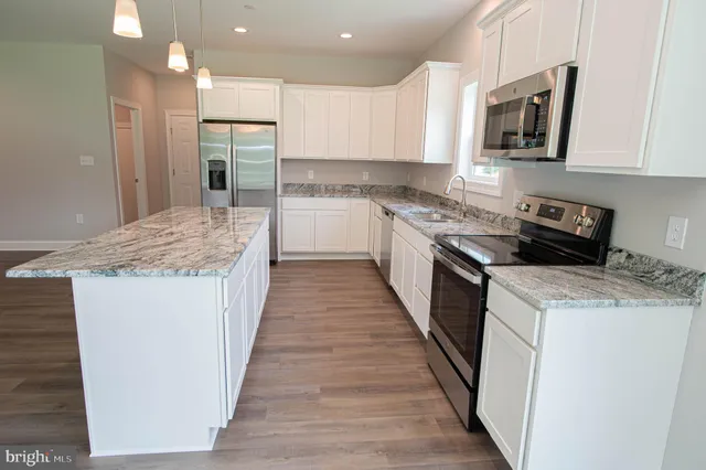 a kitchen with a sink stove and refrigerator